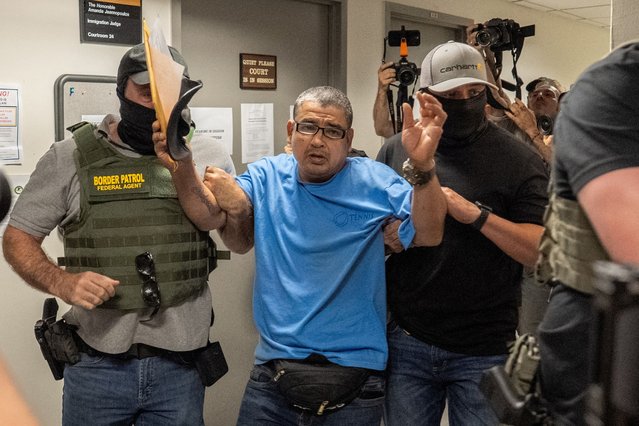 A migrant is detained by federal immigration officers at U.S. immigration court in Manhattan, in New York City on July 23, 2025. (Photo by David 'Dee' Delgado/Reuters)