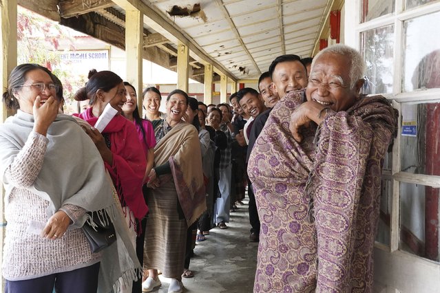 Angami Nagas laugh as an elderly man reacts to the camera at a polling station in Chedema village, in the northeastern Indian state of Nagaland, Friday, April 19, 2024. (Photo by Yirmiyan Arthur/AP Photo)
