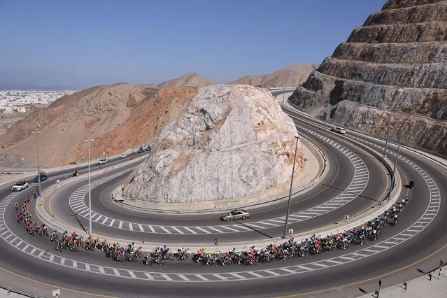 The pack rides during the first edition of the Muscat Classic on February 10, 2023. (Photo by Thomas Samson/AFP Photo)