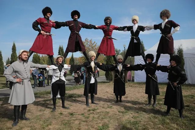 Men perform during an event marking Republic Day of North Ossetia-Alania and City Day by the Terek River in Vladikavkaz, Russia on October 11, 2020. The year 2020 marks 246 years since Ossetia became part of the Russian Empire, the 96th anniversary of the foundation of the North Ossetian Autonomous Region and the city of Vladikavkaz celebrates its 236th birthday. (Photo by Yelena Afonina/TASS)