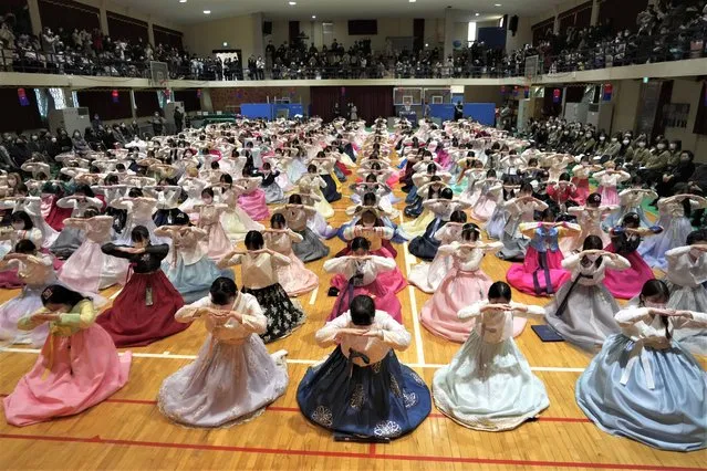 High school seniors clad in traditional attire bow during a joint graduation and coming-of-age ceremony at Dongmyung Girls' High School in Seoul South Korea, Tuesday, February 7, 2023. (Photo by Ahn Young-joon/AP Photo)