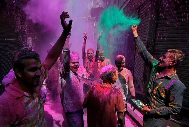People dance as they throw coloured powder at each other during Holi celebrations in an alley in Kolkata, India on March 2, 2018. (Photo by Rupak De Chowdhuri/Reuters)