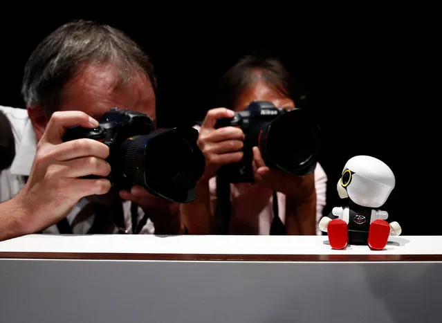 Photographers take pictures of Toyota Motor Corp's Kirobo Mini robot during a photo opportunity after a news conference in Tokyo, Japan, September 27, 2016. (Photo by Kim Kyung-Hoon/Reuters)
