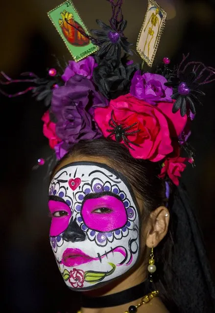 A participant gathers before the start of a candlelight procession at the end of a three-day "Day of The Dead" (Dia de los Muertos) celebration in Old Town San Diego, California November 2, 2015. (Photo by Mike Blake/Reuters)