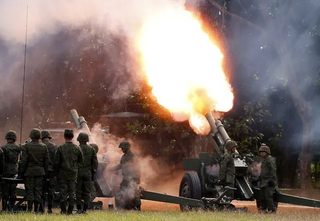 Philippine troops fire cannons to give President Rodrigo Duterte a 21-gun salute during the 121st anniversary celebration of the Philippine Army Tuesday, March 20, 2018, in Taguig city, east of Manila, Philippines. (Photo by Bullit Marquez/AP Photo)