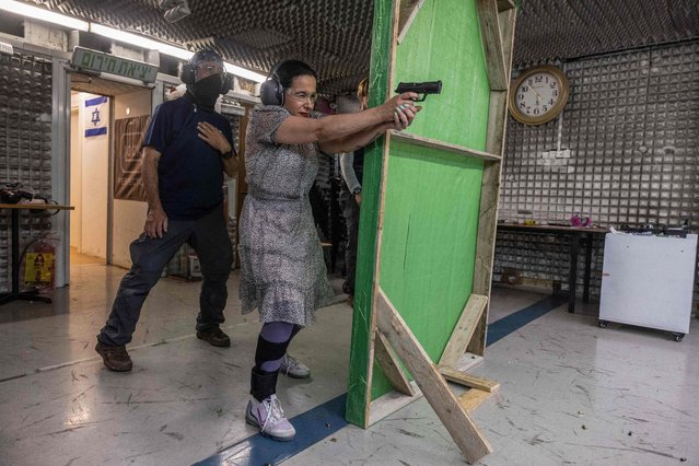A picture taken on  May 23, 2024, shows Limor Gonen practising with a gun at a shooting range in the Israeli settlement of Ariel in the Israeli occupied Palestinian West Bank. As a sense of insecurity grows across Israel following Hamas's unprecedented October 7 attack, the number of women applying for gun permits has soared, while feminist groups have criticised the arms rush. Bolstered by gun laws loosened by Israel's right-wing government, 18,000 gun permits were approved for women out of 42,000 applications, more than three times the number they held before the war, according to security ministry data. (Photo by Menahem Kahana/AFP Photo)