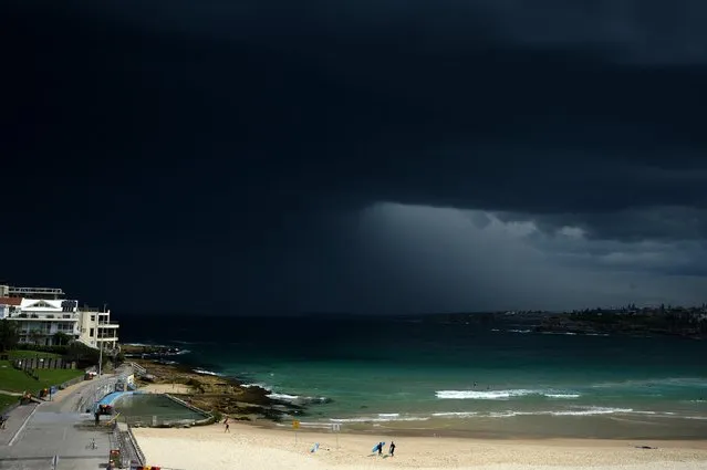 Surfers are seen leaving the water as storm clouds build over Bondi beach, in Sydney, Australia, November 13, 2015. The Bureau of Meteorology has issued a severe storm warning for thunderstorms and heavy rain for the Sydney metropolitan area as well as the Hunter, Illawarra and mid-north coast regions. (Photo by Dan Himbrechts/EPA)