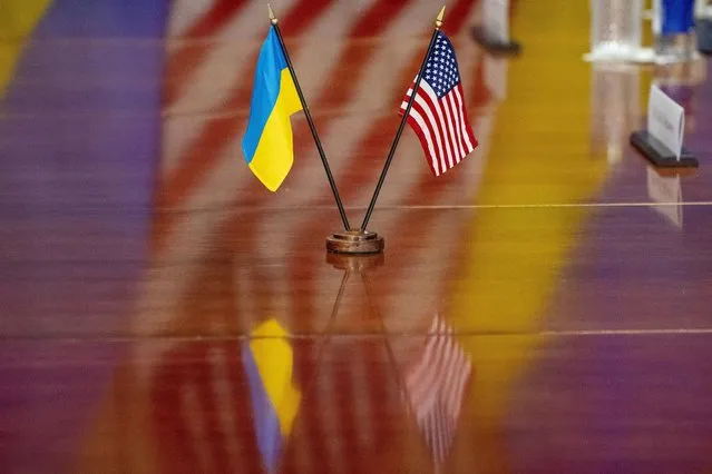 The Ukrainian and United States flags are placed on the table during a meeting with Secretary of Defense Lloyd Austin and Ukrainian Prime Minister Denys Shmyhal at the Pentagon, Wednesday, April 12, 2023, in Washington. (Photo by Alex Brandon/AP Photo)