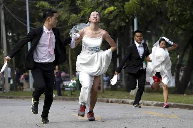 Couples participate in the "Running of the Brides" race in a park in Bangkok, Thailand, November 28, 2015. (Photo by Athit Perawongmetha/Reuters)