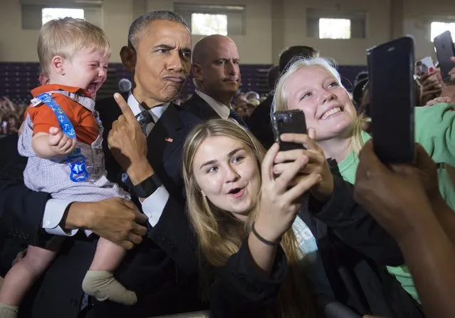 US President Barack Obama holds 10-month-old Brooks Breitwieser as he greets supporters after speaking to an overflow room during a Hillary for America campaign event for Democratic Presidential nominee Hillary Clinton at the Capital University Field House in Columbus, Ohio, November 1, 2016. (Photo by Saul Loeb/AFP Photo)