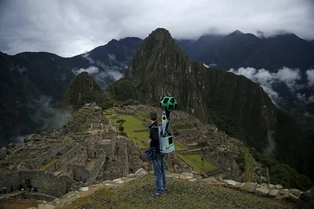 Daniel Filip, Tech Lead Manager for Google Maps, carries the Trekker, a 15-camera device, while mapping the Inca citadel of Machu Picchu for Google Street View in Cuzco, Peru, August 11, 2015. (Photo by Pilar Olivares/Reuters)