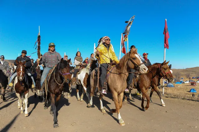 Horse riders from the Bigfoot Riders, Dakota 38 Riders, Spirit Riders and the Bigfoot Youth Riders arrive at the Oceti Sakowin camp during a protest of the Dakota Access pipeline on the Standing Rock Indian Reservation near Cannon Ball, North Dakota November 5, 2016. (Photo by Stephanie Keith/Reuters)