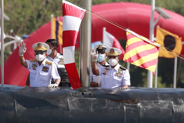 Myanmar's commander-in-chief Senior General Min Aung Hlaing (L) waves as he inspects a submarine during the welcoming ceremony for new warships and a submarine to mark the Myanmar Navy's 73rd anniversary at the Irrawaddy Naval Region Command headquarters in Yangon on December 24, 2020. (Photo by AFP Photo/Stringer)