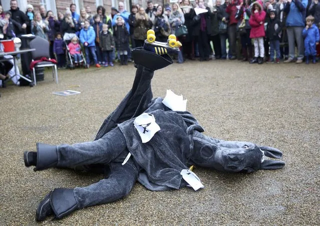 Participants fall as they perform a dance in costume  before the start of the annual London Pantomime Horse Race in Greenwich, Britain December 13, 2015. (Photo by Neil Hall/Reuters)