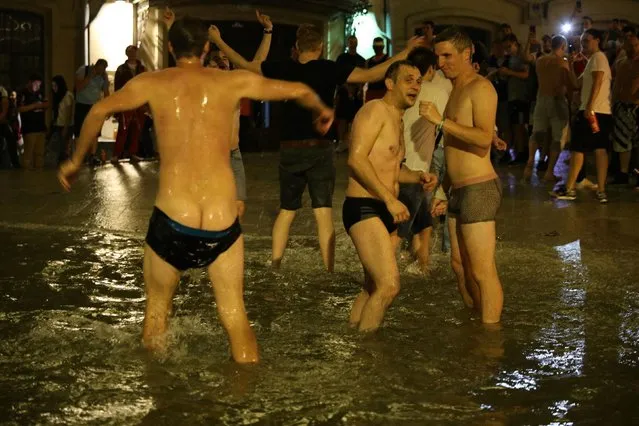 Russian fans jump into a fountain to celebrate after Russia defeated Spain in the Round of 16 match during the 2018 FIFA World Cup on a square in Moscow, Russia, 1 July 2018. Jubilant Russia fans stripped to their pants as they celebrated knocking Spain out of the World Cup. An army of ecstatic supporters peeled off and jumped in a fountain after their team pulled off a huge shock with a win on penalties. (Photo by PA Wire)