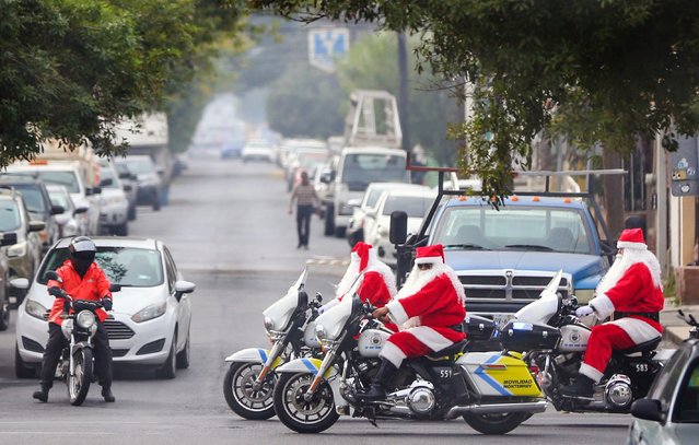 Municipal police and traffic agents dressed as Santa Claus ride through the streets of Monterrey, Nuevo León, Mexico, on December 17, 2024. (Photo by Julio Cesar Aguilar/AFP Photo)