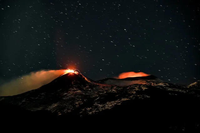 A night view of the southeast crater (L) and the Intra-crater in the Bocca Nuova and Voragine craters (R) of Etna volcano during explosive activity with lava fountains on February 15, 2021 in Catania, Italy. The National Institute of Geophysics and Volcanology, Etna Observatory, explained that since the early hours of 15 February a gradual intensification of explosive activity has been observed at the Southeast Crater while activity continued at the eastern mouths of the same crater. (Photo by Fabrizio Villa/Getty Images)