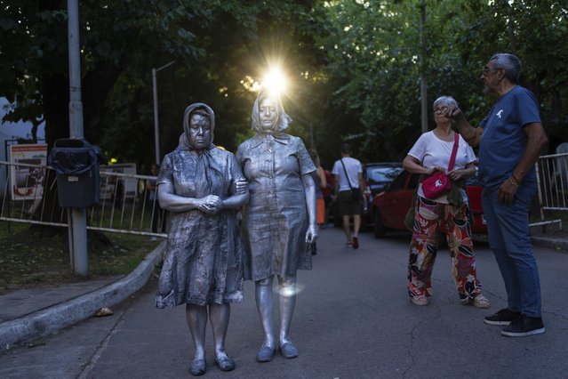 Women perform dressed as members of Mothers of Plaza as they protest against layoffs announced by the government of Javier Milei at the Haroldo Conti Cultural Center in Buenos Aires, Argentina, Saturday, January 4, 2025. (Photo by Rodrigo Abd/AP Photo)