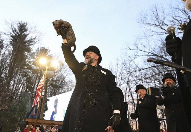 Groundhog Club handler A.J. Dereume holds Punxsutawney Phil, the weather prognosticating groundhog, during the 139th celebration of Groundhog Day on Gobbler's Knob in Punxsutawney, Pa., Sunday, February 2, 2025. Phil's handlers said that the groundhog has forecast six more weeks of winter. (Photo by Barry Reeger/AP Photo)