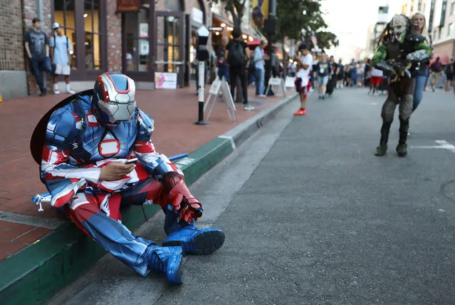 A cosplayer checks his phone outside San Diego Comic-Con on July 19, 2018 in San Diego, California. Thousands of revelers are arriving for the festivities at the annual comic and entertainment convention. (Photo by Mario Tama/Getty Images)