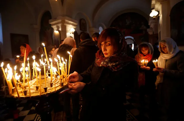 People attend a religious service inside a church during St. George's Day celebration in the village of Ikalto, Georgia November 23, 2016. (Photo by David Mdzinarishvili/Reuters)