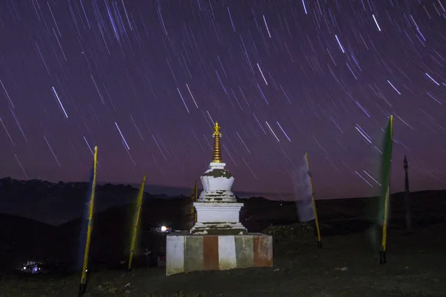In this photograph taken on July 8, 2018, a stupa is seen at night near Tnagyud Gompa monastery in Komik in Spiti Valley in the northern state of Himachal Pradesh. (Photo by Xavier Galiana/AFP Photo)