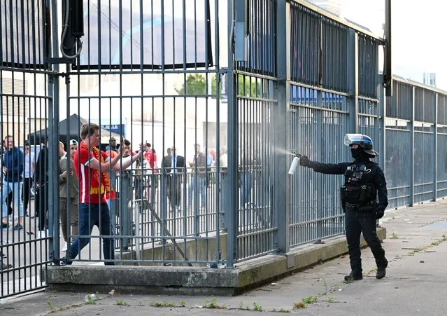 Police spray tear gas at Liverpool fans outside the stadium as fans struggle to enter prior to the UEFA Champions League final match between Liverpool FC and Real Madrid at Stade de France on May 28, 2022 in Paris, France. (Photo by Matthias Hangst/Getty Images)