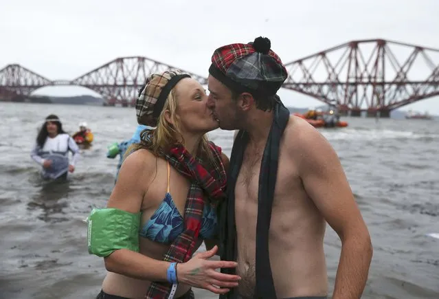 Swimmers kiss as they leave the water during the New Year's Day Loony Dook swim at South Queensferry in Scotland, Britain January 1, 2016. (Photo by Russell Cheyne/Reuters)