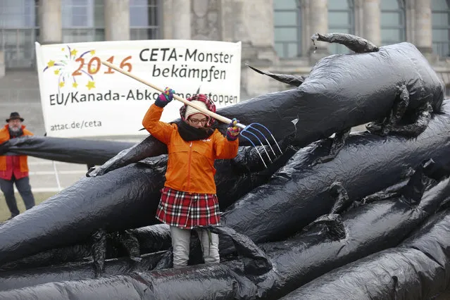 Activists from the anti-globalisation organisation ATTAC (Association for the Taxation of financial Transactions and Aid to Citizens) protest against planned trade pact CETA (Comprehensive Economic and Trade Agreement) with the U.S. and Canada, in Berlin, Germany January 4, 2016. (Photo by Hannibal Hanschke/Reuters)