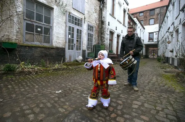 Hugo Belleri, a three-year-old boy and the youngest Gilles of Binche, walks on his way to the parade of Young Gilles of Binche during the carnival event in Binche February 17, 2015. (Photo by Yves Herman/Reuters)