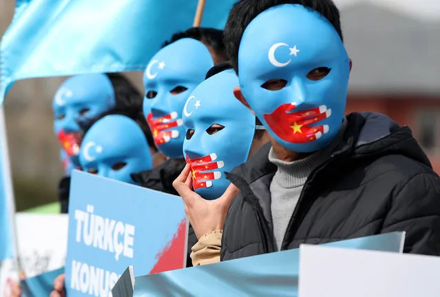 Uyghur protesters who have not heard from their families living in East Turkestan hold Uyghur flags and placards reading on “it is not a joke, it is a genocide” during a protest against China, in Istanbul, Turkey, 01 April 2021. The protest aims to highlight the critical situation of alleged human rights abuses of the Uyghur people and many other minority groups across the Xinjiang (East Turkestan) area in China. (Photo by Tolga Bozoglu/EPA/EFE)