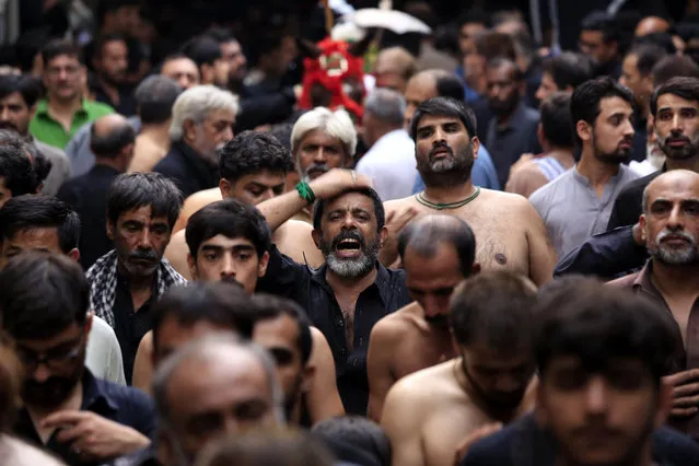 Shiite Muslim attend a Ashura Day procession in Peshawar, Pakistan, 21 September 2018. Shiite Muslims across the world are observing Muharram, the first month of the Islamic calendar. The climax of Muharram is the Ashura festival commemorating the martyrdom of Imam Hussein, a grandson of the Prophet Muhammad in the Iraqi city of Karbala in the seventh century. (Photo by Arshad Arbab/EPA/EFE)