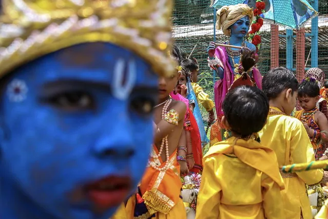 Indian school children, some with their faces painted in blue, and dressed as the Hindu god Lord Krishna take part in the Janmashtami festival celebrations at the Shivaji Shikshan Sanstha – multipurpose technical high school, in Mumbai, India, 05 September 2023. Janmashtami is an annual Hindu festival celebrating the birth anniversary of Lord Krishna. (Photo by Divyakant Solanki/EPA)
