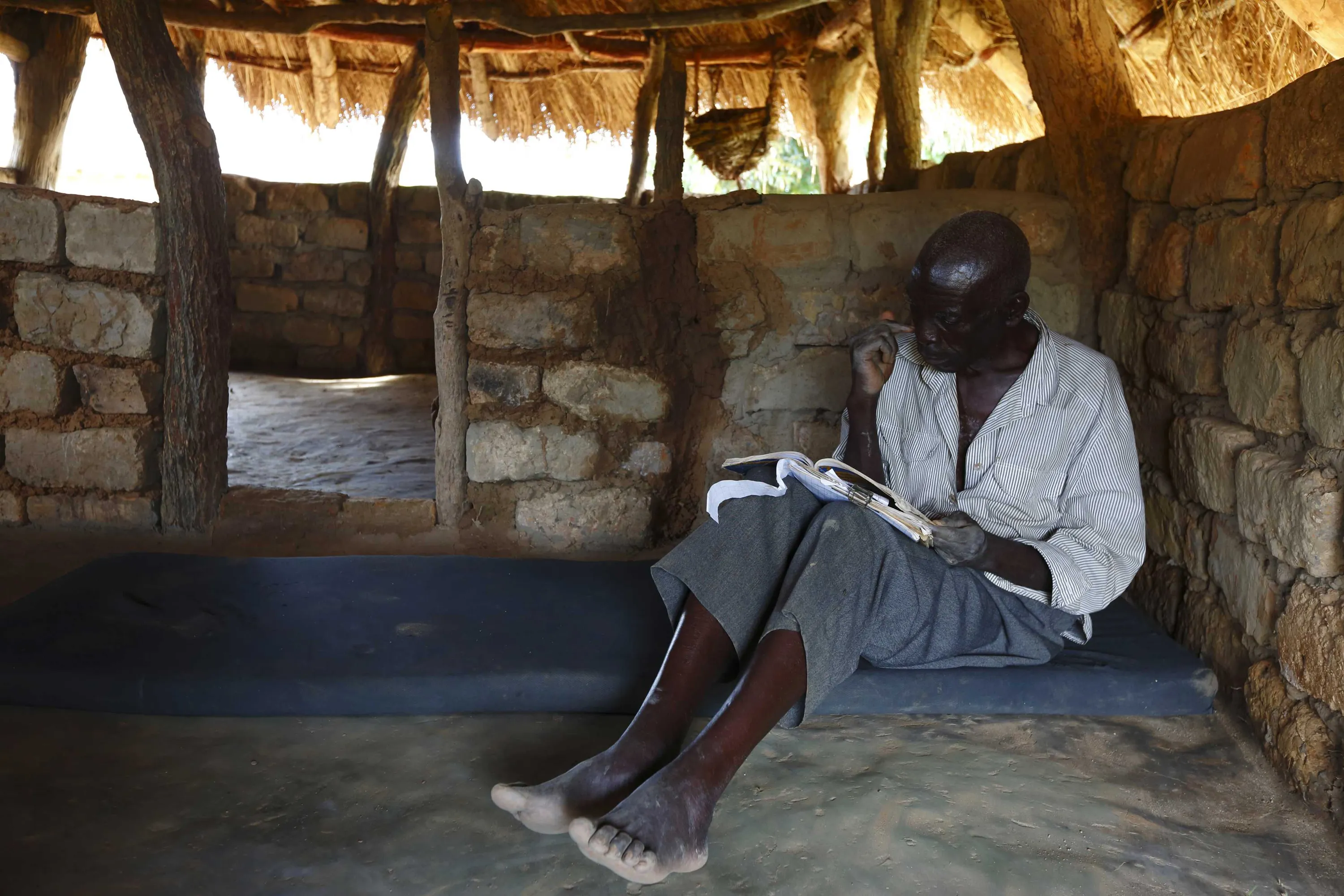 Next picture →. HIV-positive 71-year-old Sylverio Hachiploa reads in his th...