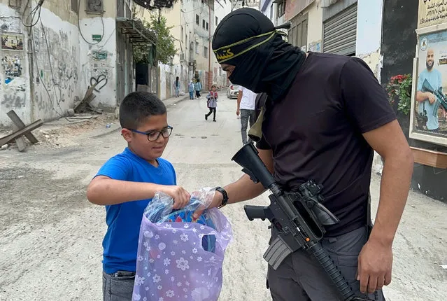 Members of the Jenin Battalion distribut school bags and stationery to the children of the Jenin camp in the West Bank on August 20, 2023. (Photo by APAImages/Rex Features/Shutterstock)