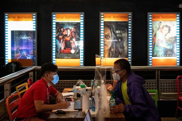 A man registers for a vaccine against the coronavirus in a cinema turned into a vaccination site in San Juan City, Metro Manila, Philippines, June 2, 2021. (Photo by Eloisa Lopez/Reuters)