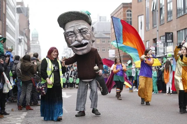 The St Patrick's day parade makes it's way through the centre of Belfast, Northern Ireland, Tuesday, March 17, 2015. (Photo by Peter Morrison/AP Photo)