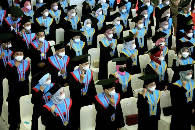 Graduates wearing protective masks attend face-to-face graduations at a campus in Makassar, South Sulawesi Province, Indonesia on June 5, 2021. (Photo by Arnas Padda/Antara Foto via Reuters)