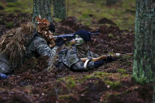 Participiants secure a position during a territorial defence training organised by paramilitary group SJS Strzelec (Shooters Association) in the forest near Minsk Mazowiecki, eastern Poland March 14, 2014. (Photo by Kacper Pempel/Reuters)