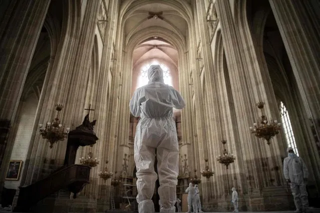 Journalists and employees of the DRAC (Regional Directorate of Cultural Affairs) visit the Cathedral of St. Peter and St. Paul of Nantes, western France, on June 30, 2021, almost one year after it was severely damaged by a fire. (Photo by Loic Venance/AFP Photo)