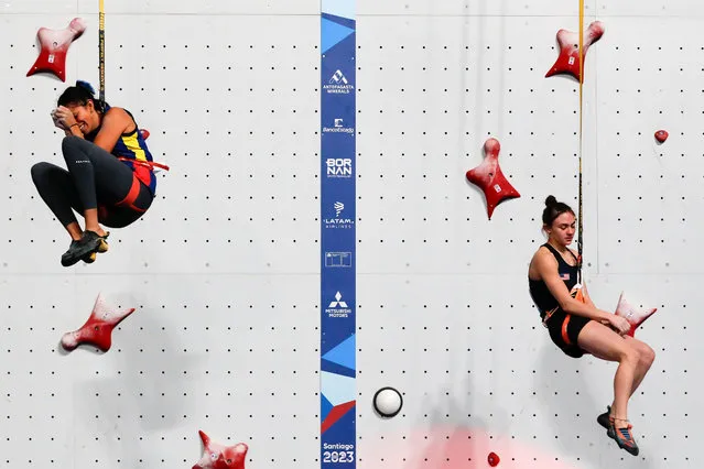 Sophia Curcio (right) of the US and Andrea Rojas of Ecuador react at the women's speed sport climbing event during the Pan American Games in Santiago, Chile on October 21, 2023. (Photo by Ailen Diaz/EPA/EFE)