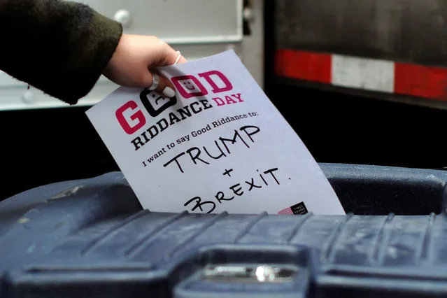 A participant throws a piece of paper reading “Trump and Brexit” into a trash can to be shredded during “Good Riddance Day” in Times Square, New York City, U.S., December 28, 2016. Good Riddance Day is an annual event held in New York City for people to shred pieces of paper representing their bad memories or things they want to get rid of before the New Year. (Photo by Darren Ornitz/Reuters)