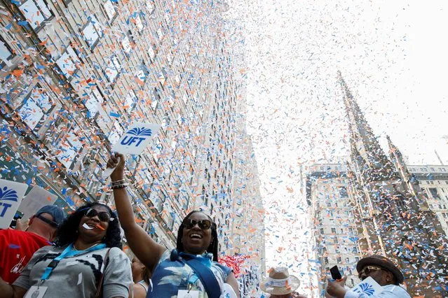 People take part in the Hometown Heroes ticker tape parade, to honor essential workers for their work during the outbreak of the coronavirus disease (COVID-19), up New York City's “Canyon of Heroes” in lower Manhattan in New York City, New York, U.S., July 7, 2021. (Photo by Brendan McDermid/Reuters)