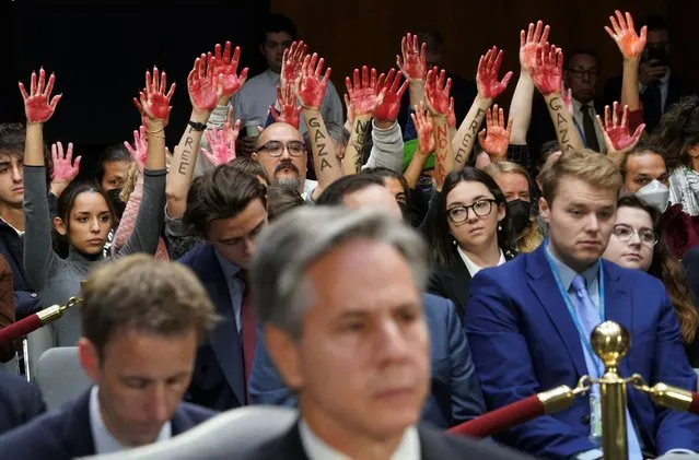 Anti-war protesters raise their “bloody” hands behind U.S. Secretary of State Antony Blinken during a Senate Appropriations Committee hearing on President Biden's $106 billion national security supplemental funding request to support Israel and Ukraine, as well as bolster border security, on Capitol Hill in Washington, U.S., October 31, 2023. (Photo by Kevin Lamarque/Reuters)