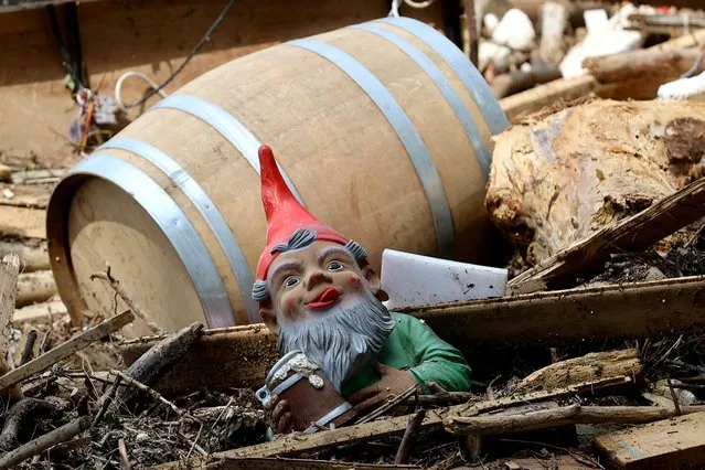 A garden dwarf and a barrel lie among the debris following floods caused by heavy rainfalls in Bad Neuenahr-Ahrweiler, Germany, July 18, 2021. (Photo by Wolfgang Rattay/Reuters)