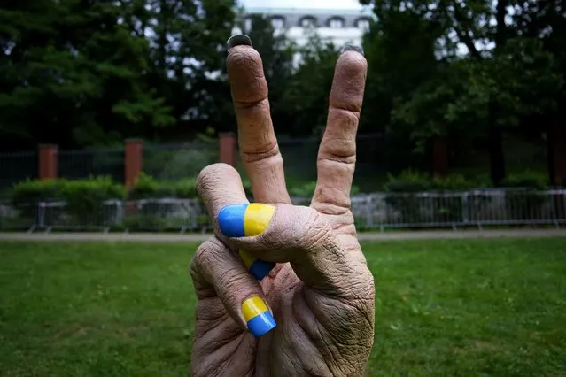 A statue of a hand with finger nails painted in Ukraine's national colors was placed in front of the Russian embassy in Prague, Czech Republic, Wednesday, August 24, 2022. European leaders are pledging unwavering support for Ukraine as the war-torn country marks its Independence Day. The commemorations Wednesday coincide with the six-month milestone of Russia's invasion. (Photo by Petr David Josek/AP Photo)