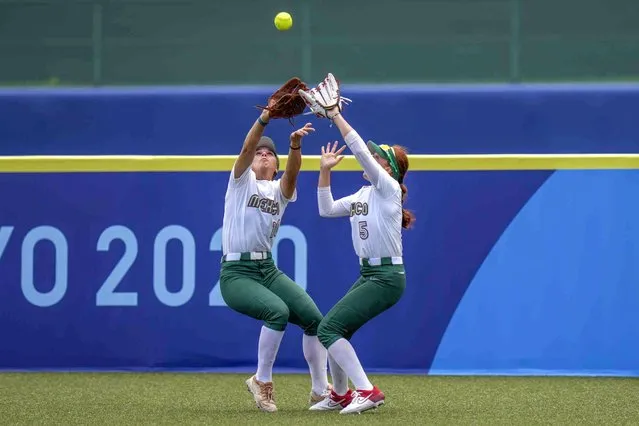 Mexico's Nicole Rangel, left, and Suzannah Brookshire collide as they attempt to take a catch during the softball game between the Mexico and Japan at the 2020 Summer Olympics, Thursday, July 22, 2021, in Fukushima , Japan. (Photo by Jae C. Hong/AP Photo)