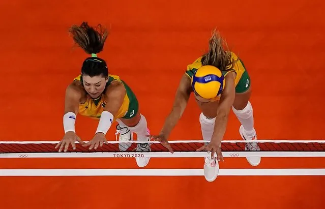 Rosamaria of Brazil and Carol Gattaz of Brazil in action in the women's semi-final volleyball match between Brazil and South Korea during the Tokyo 2020 Olympic Games at Ariake Arena in Tokyo on August 6, 2021. (Photo by Carlos Garcia Rawlins/Reuters)