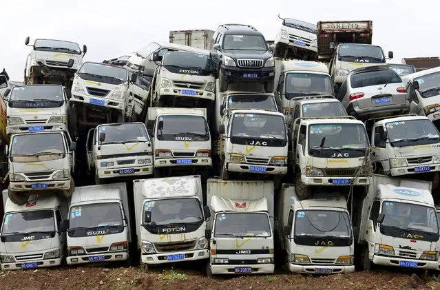 Scrapped high-emission vehicles are seen piled up at a dump site of a recycling centre, waiting to be dismantled, in Yiwu, Zhejiang province April 8, 2015. According to local media, the city of Yiwu is planning to get rid of approximately 22,000 highly-polluting vehicles by the end of this year. (Photo by Reuters/China Daily)