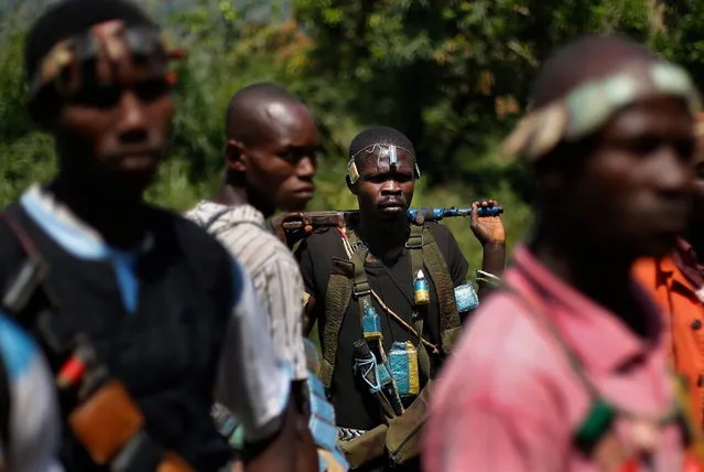 Anti-Balaka Christian militiamen walk through a forest clearing outside Central African Republic's capital Bangui Sunday December 15, 2013. (Photo by Jerome Delay/AP Photo)